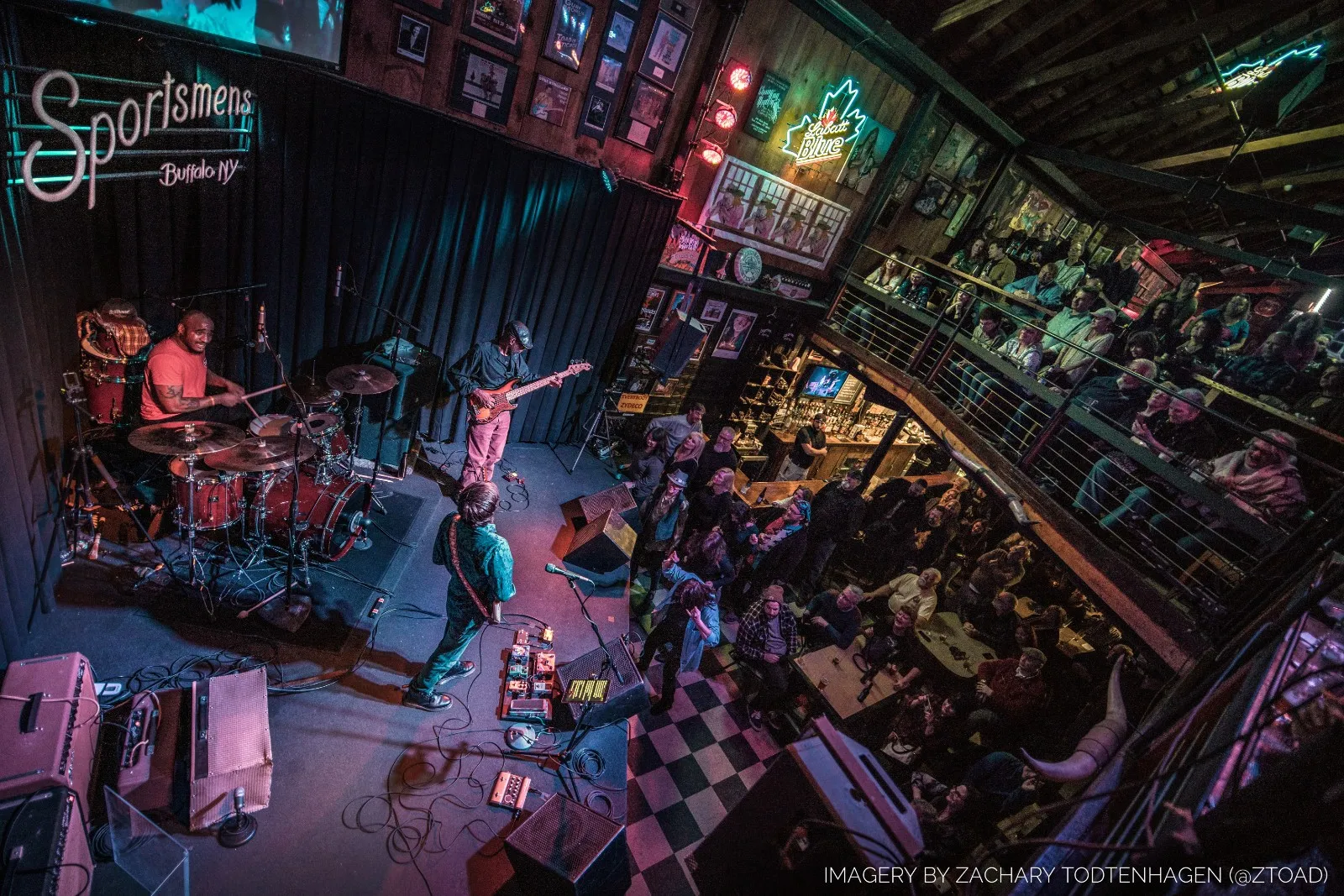 Overhead view of the Hayden Fogle Band on stage at Sportsmens Tavern in Buffalo, playing to a full room with people watching from the balcony.