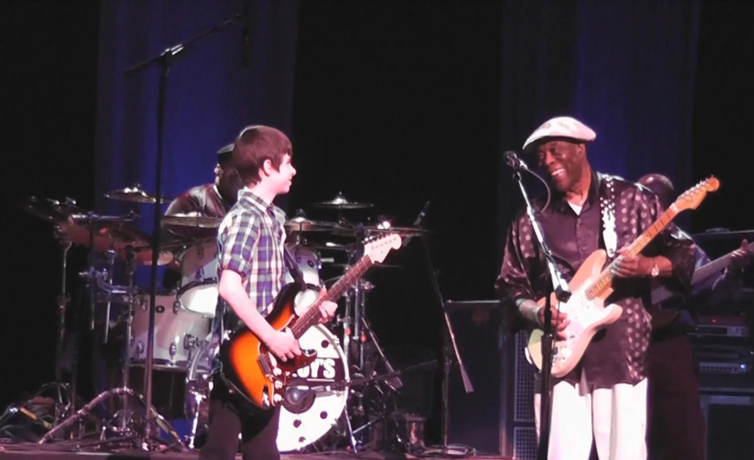 A young Hayden Fogle standing with blues legend Buddy Guy.